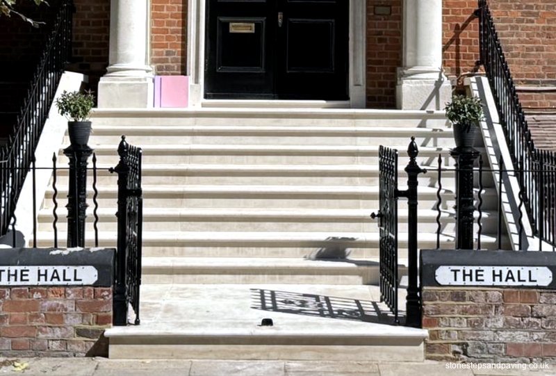 After rebuild: Completed pale stone school entrance staircase