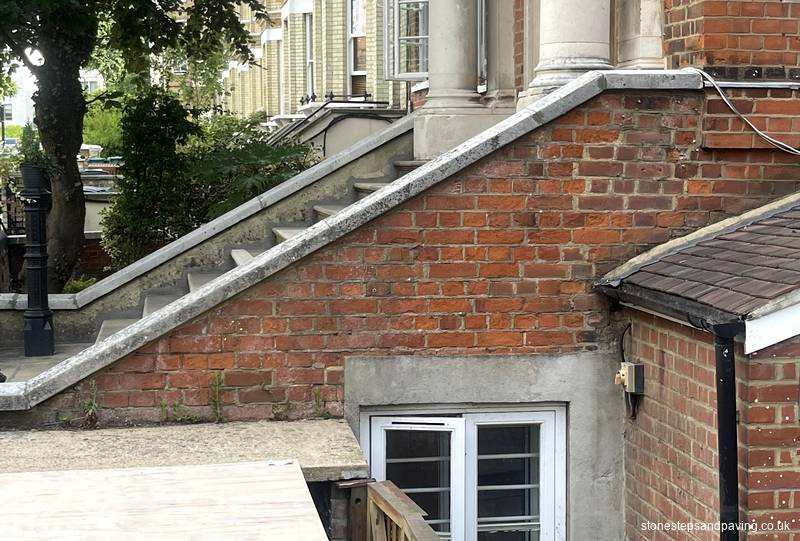 Worn and cracked Yorkstone school entrance steps