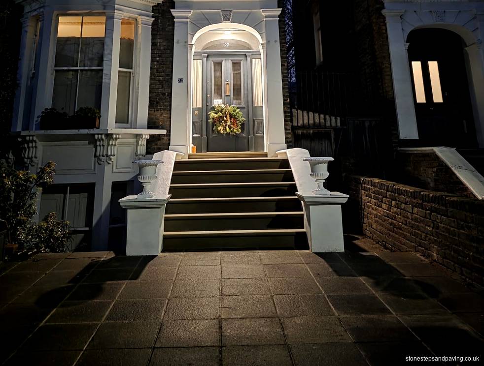New Yorkstone entrance steps for a home on Navarino Road, Hackney E8. By the Stone Steps and Paving team, London Completed Yorkstone entrance steps between white urn-topped piers, leading to a wreathed front door on Navarino Road, Hackney E8